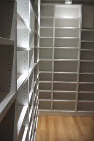 Bijele police od poda do stropa u garderobi