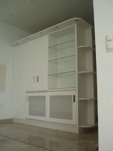 Bijeli zidni element sa staklenim policama i kliznim vratima od mliječnog stakla